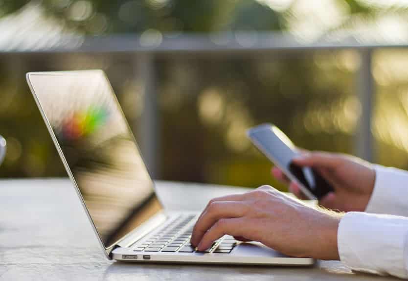 businessman working with laptop and cell phone